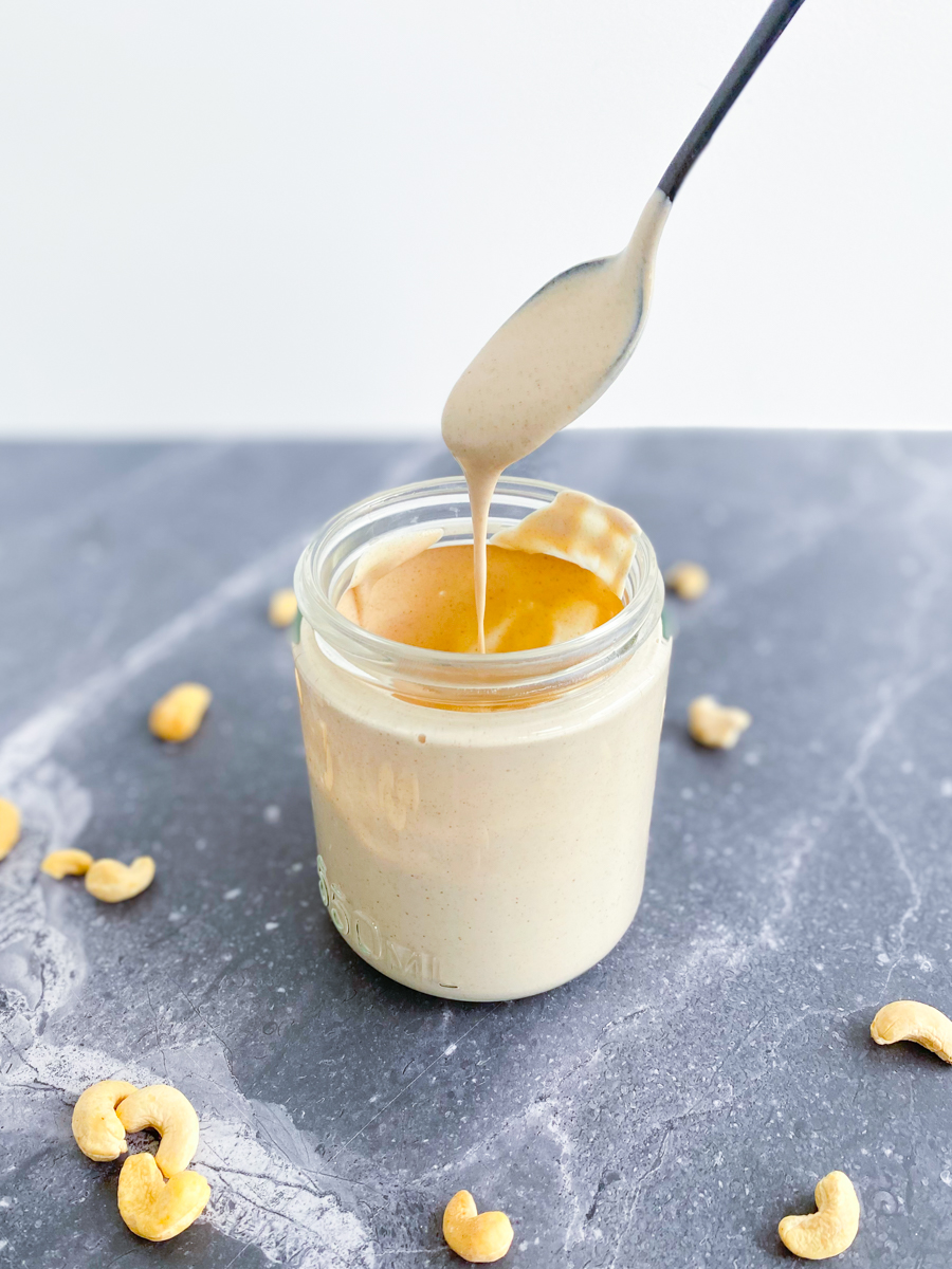 Cashew Cream in a jar with spoon on top