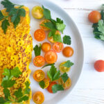 Vegan Chickpea Omelette on a plate, garnished with tomatoes and parsley