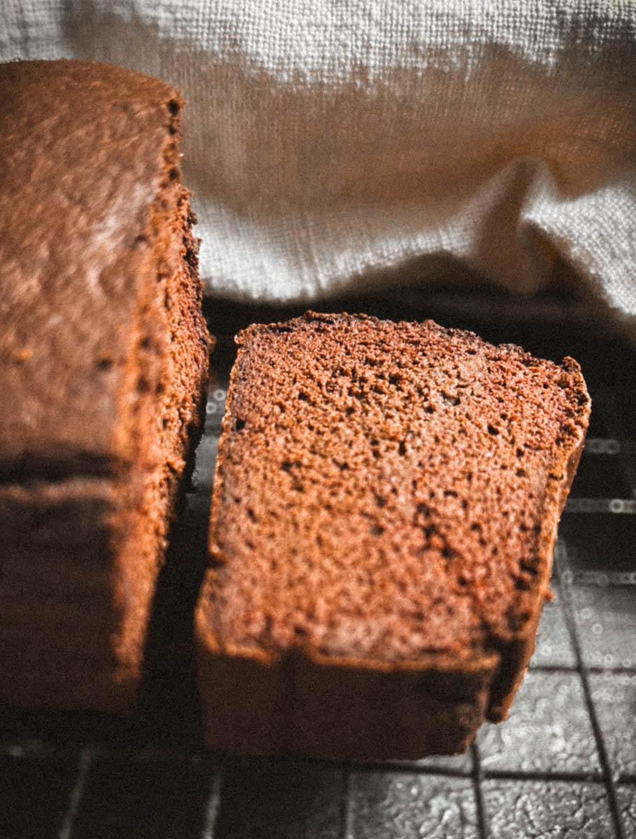 Chocolate buckwheat cake sliced on a cooling rack